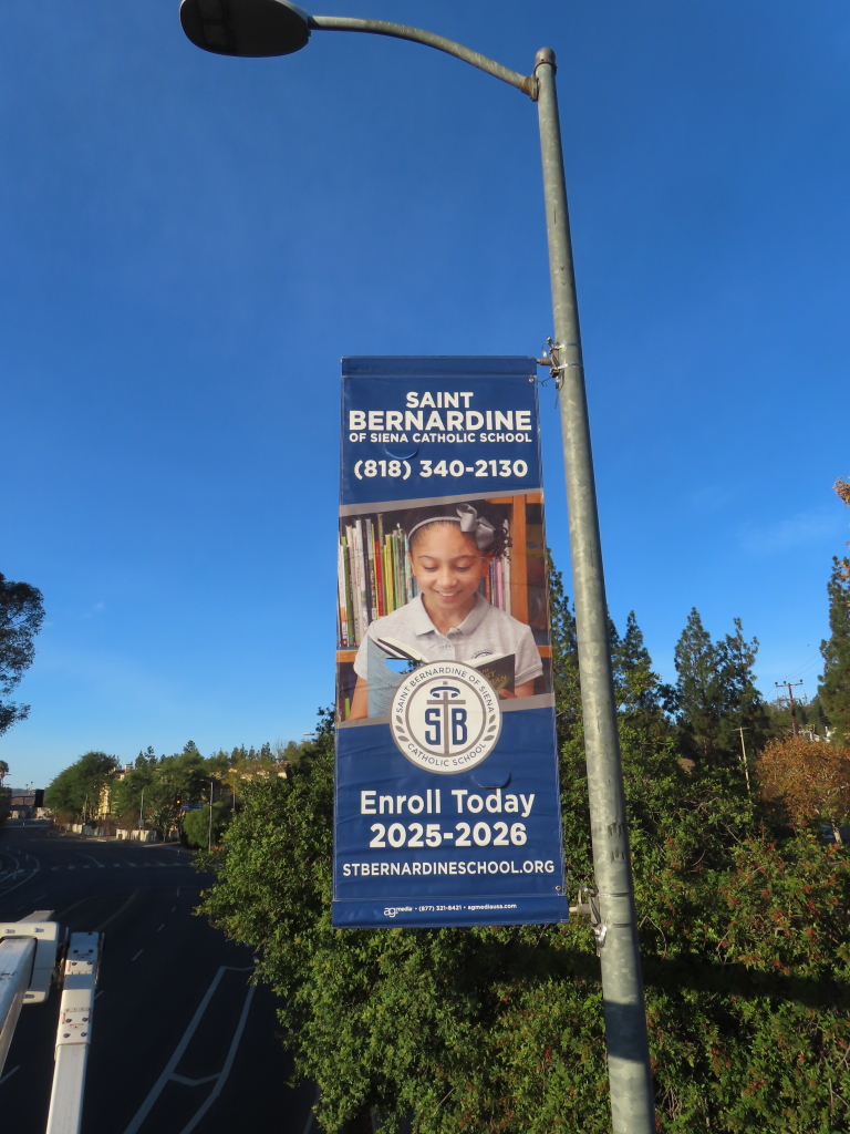 Saint Bernardine Catholic School banner with student reading